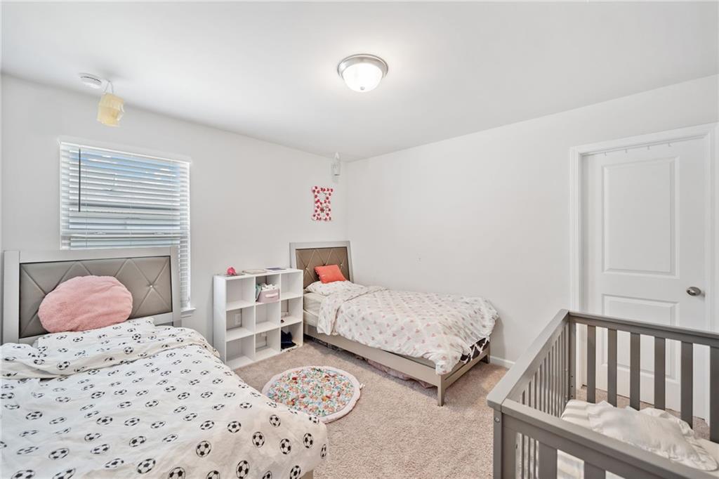 368 Murray Way Lilburn, GA 30047 - Photo 32 of 54 a bedroom with two beds and a window