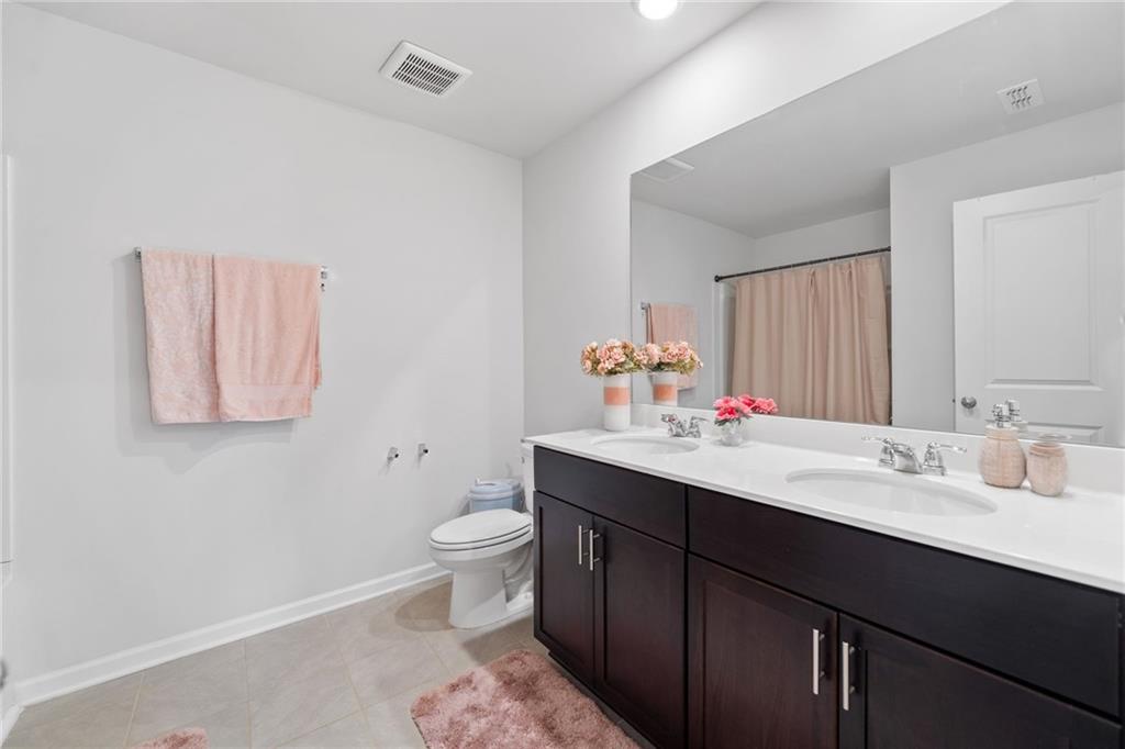 368 Murray Way Lilburn, GA 30047 - Photo 33 of 54 a bathroom with a sink and a mirror