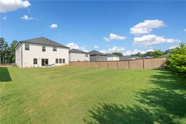 a view of a house with a yard and lake view