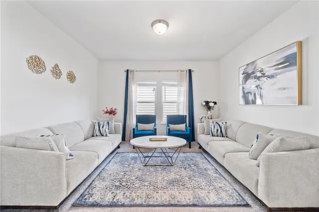 a living room with furniture and a rug