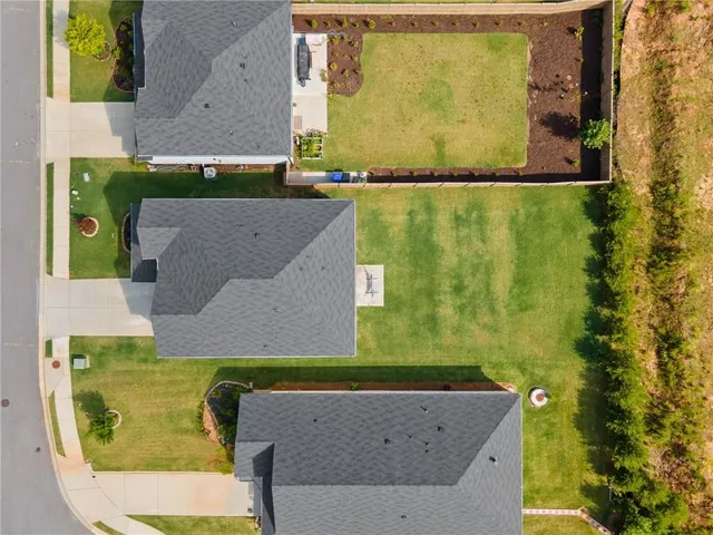 a swimming pool with outdoor seating and yard