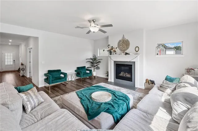 a living room with furniture a fireplace and a chandelier