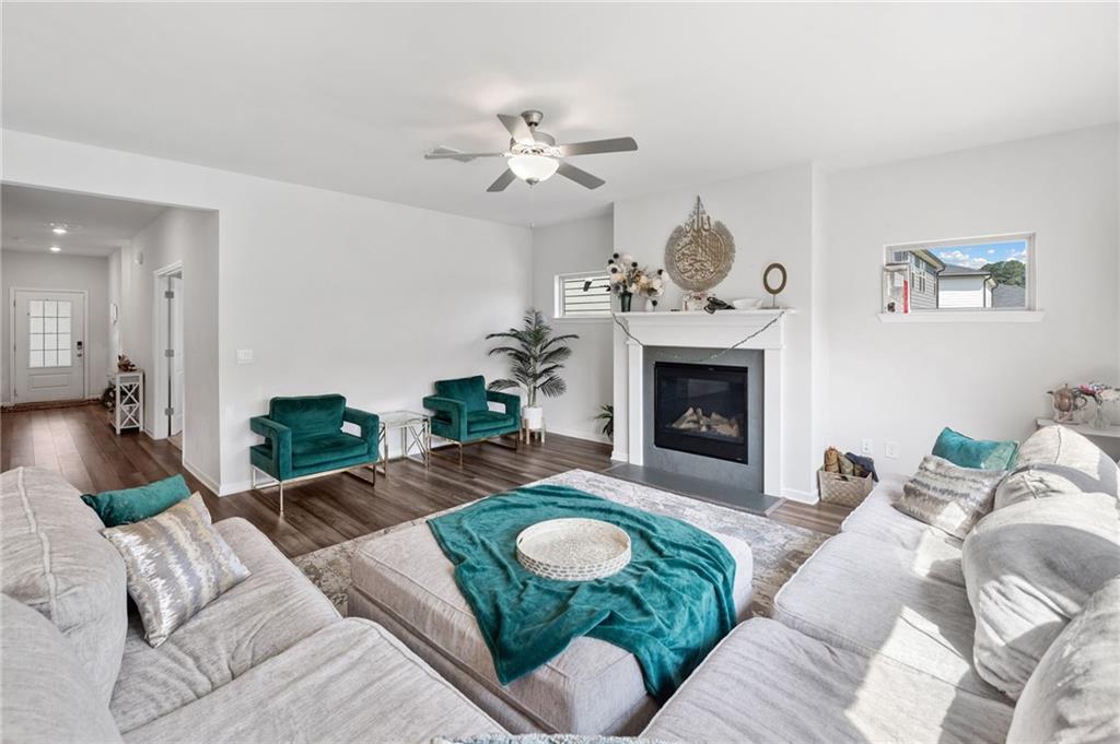 368 Murray Way Lilburn, GA 30047 - Photo 7 of 54 a living room with furniture a fireplace and a chandelier