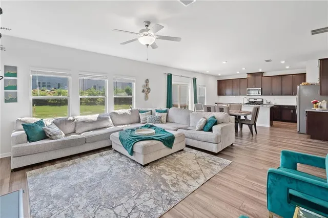 a living room with furniture and a large window