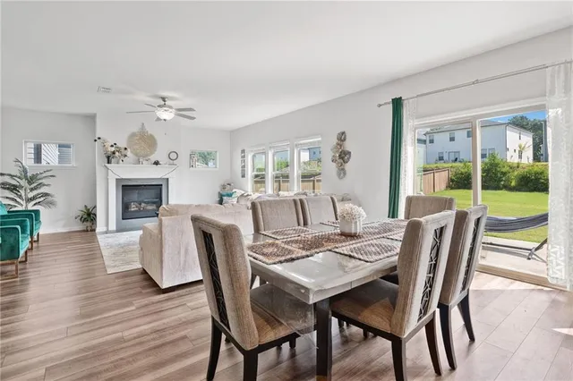 a view of a dining room with furniture window and wooden floor
