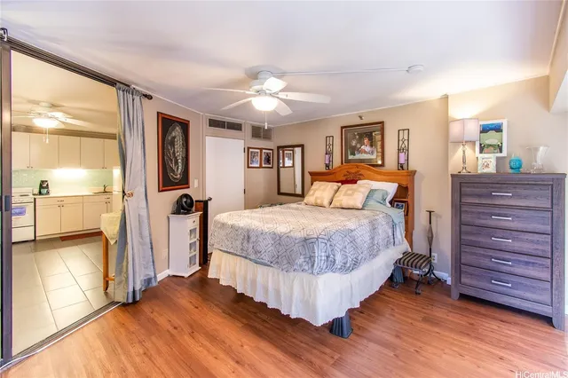a bedroom with a large bed and a flat tv screen on dresser