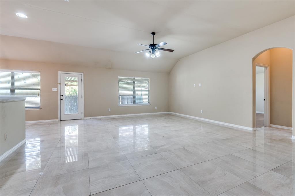 1615 Ridgemar Drive Grand Prairie, TX 75051 - Photo 11 of 25 an empty room with windows and ceiling fan