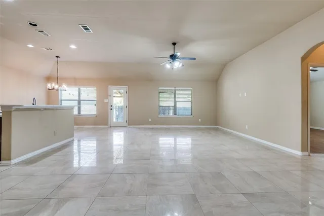 a view of an empty room with a kitchen