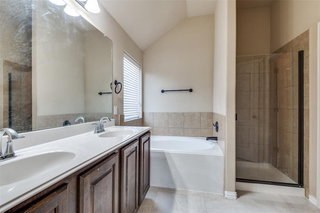 1615 Ridgemar Drive Grand Prairie, TX 75051 - Photo 23 of 25 a bathroom with a bathtub and a sink