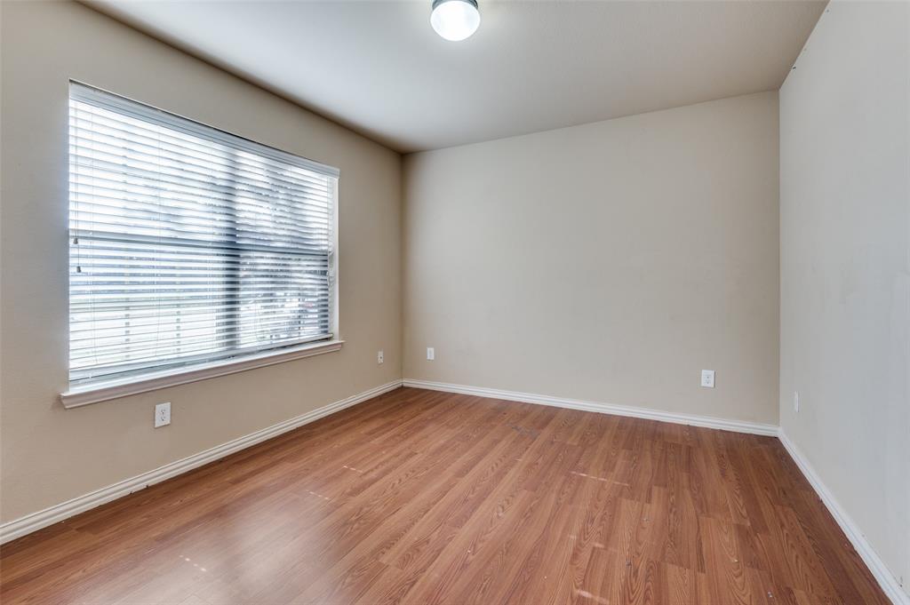 1615 Ridgemar Drive Grand Prairie, TX 75051 - Photo 4 of 25 wooden floor in an empty room with a window