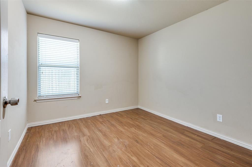 1615 Ridgemar Drive Grand Prairie, TX 75051 - Photo 6 of 25 wooden floor in an empty room with a window