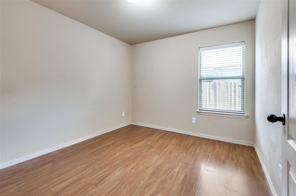 1615 Ridgemar Drive Grand Prairie, TX 75051 - Photo 8 of 25 wooden floor in an empty room with a window