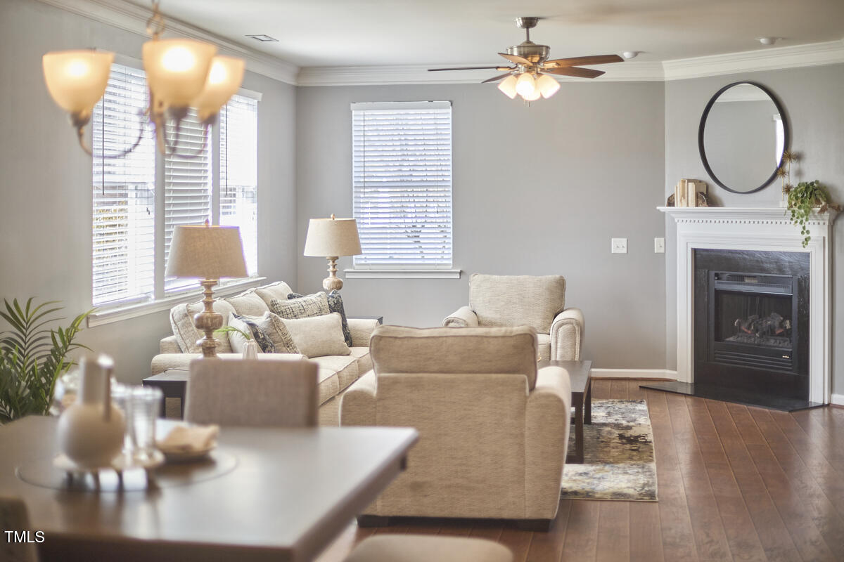442 Steel Hopper Way Garner, NC 27529 - Photo 11 of 45 a living room with furniture a window and a fireplace
