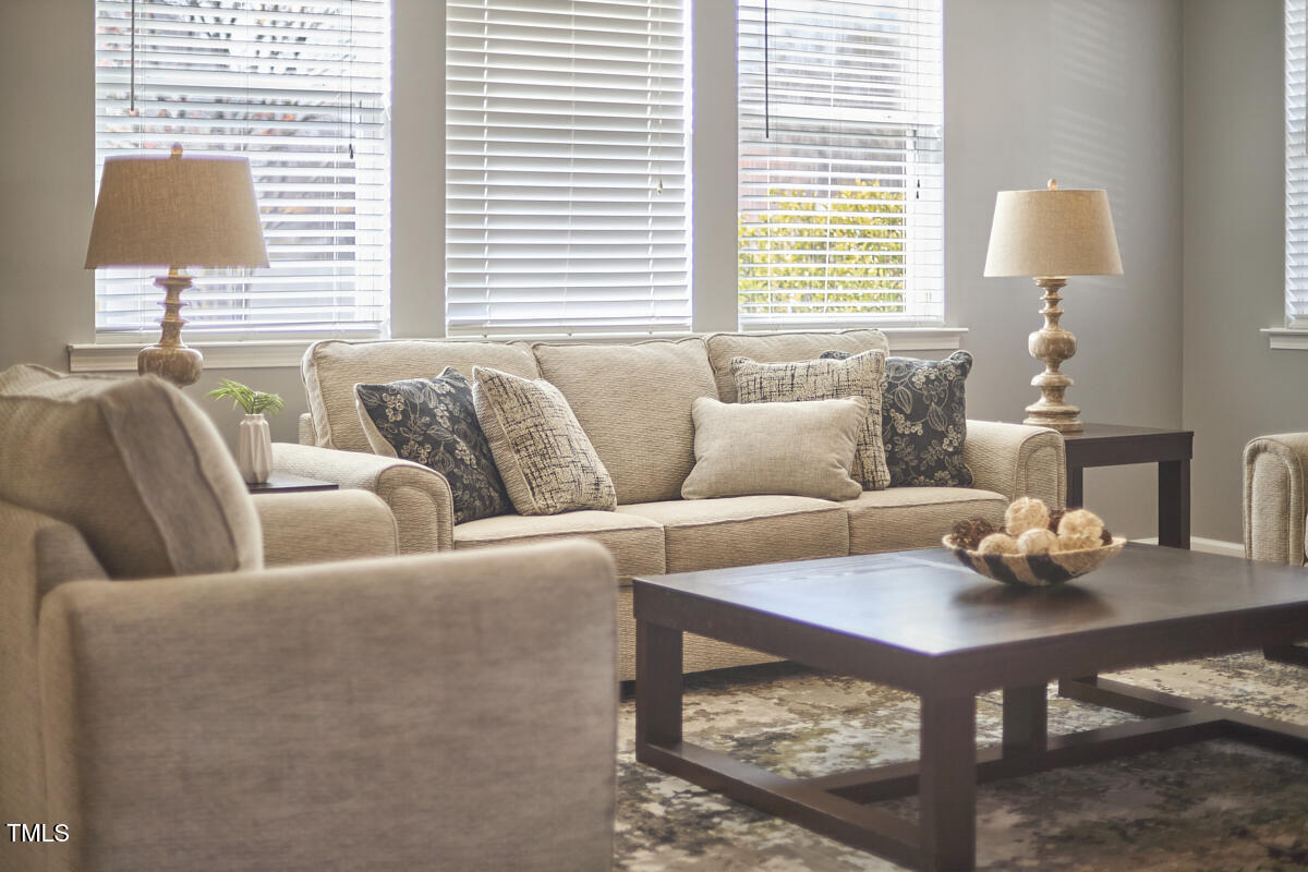 442 Steel Hopper Way Garner, NC 27529 - Photo 12 of 45 a living room with furniture a window and a lamp