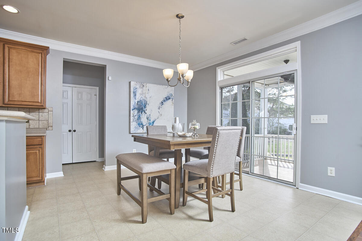 442 Steel Hopper Way Garner, NC 27529 - Photo 13 of 45 a dining room with furniture a chandelier and window