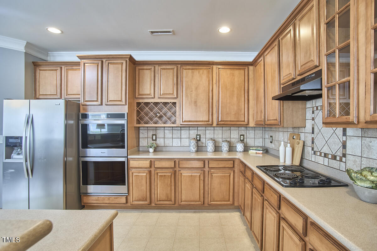 442 Steel Hopper Way Garner, NC 27529 - Photo 18 of 45 a kitchen with stainless steel appliances granite countertop a stove a sink and a refrigerator