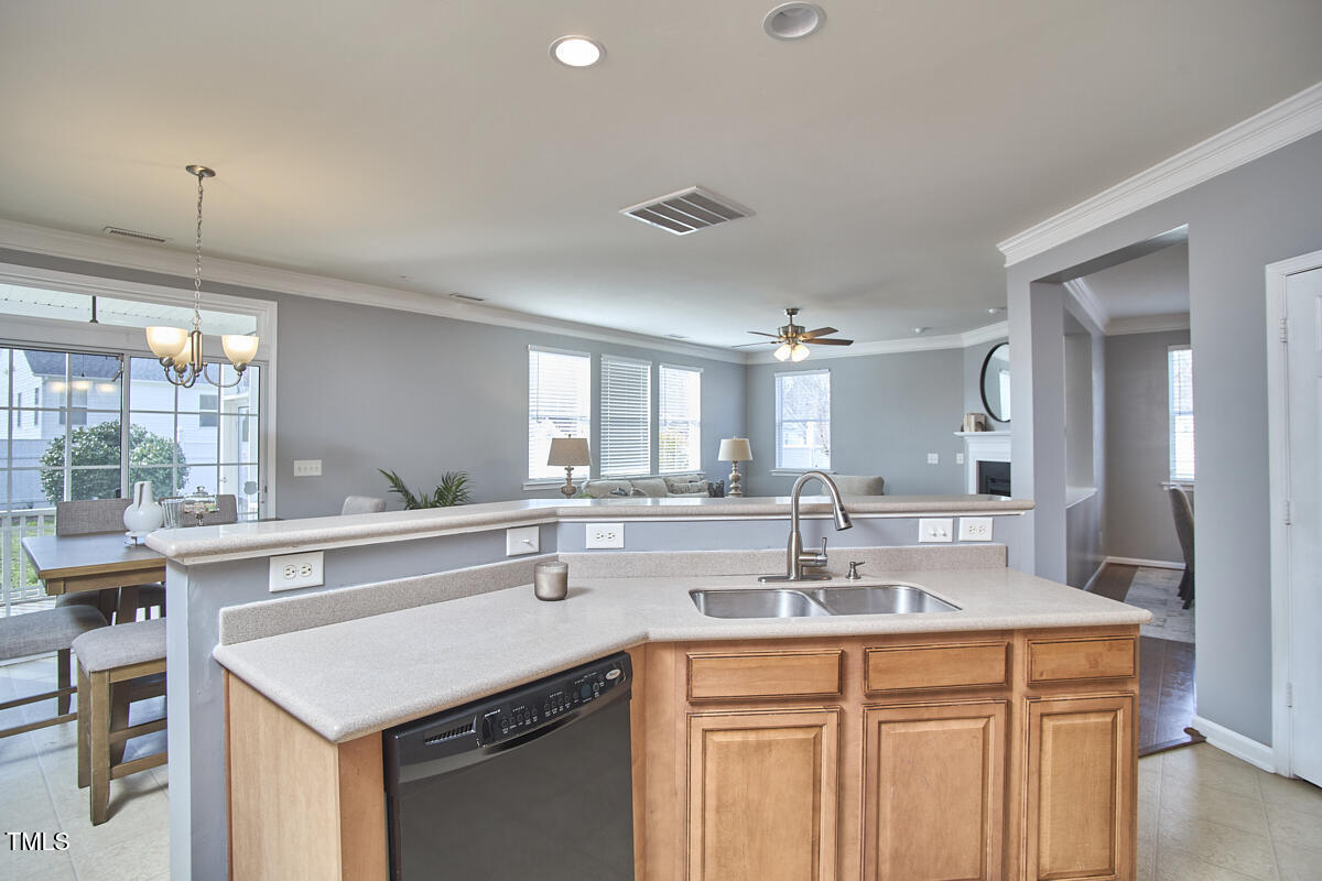442 Steel Hopper Way Garner, NC 27529 - Photo 19 of 45 a kitchen with stainless steel appliances granite countertop a sink and dishwasher with wooden floor