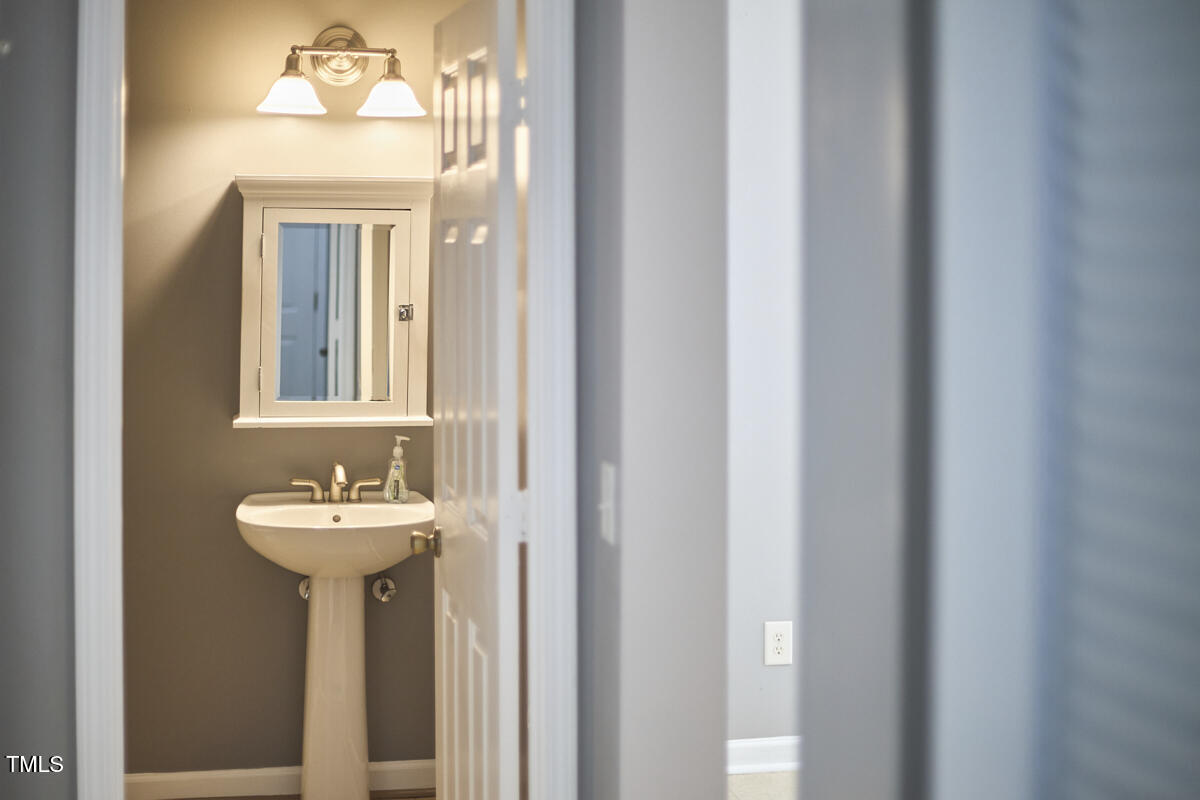 442 Steel Hopper Way Garner, NC 27529 - Photo 20 of 45 a bathroom with a sink and a mirror