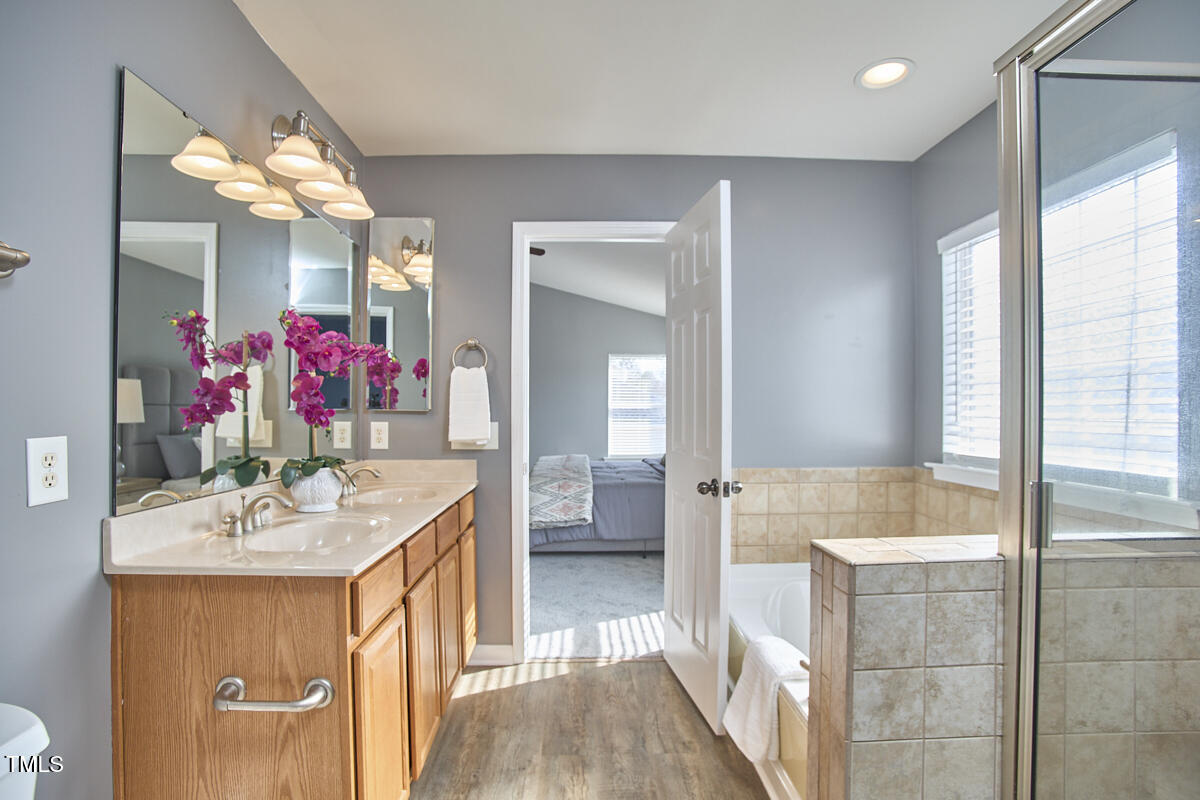 442 Steel Hopper Way Garner, NC 27529 - Photo 29 of 45 a bathroom with a sink vanity tub and shower