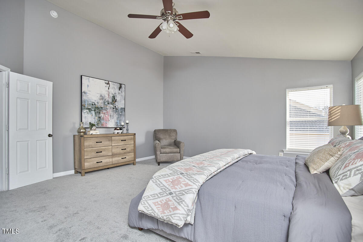 442 Steel Hopper Way Garner, NC 27529 - Photo 32 of 45 a bedroom with a bed and chair
