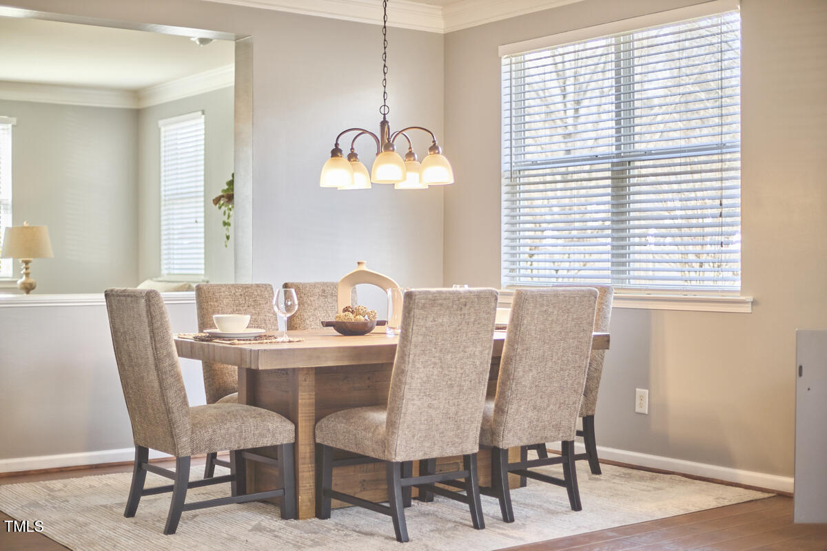 442 Steel Hopper Way Garner, NC 27529 - Photo 6 of 45 a view of a dining room with furniture and chandelier