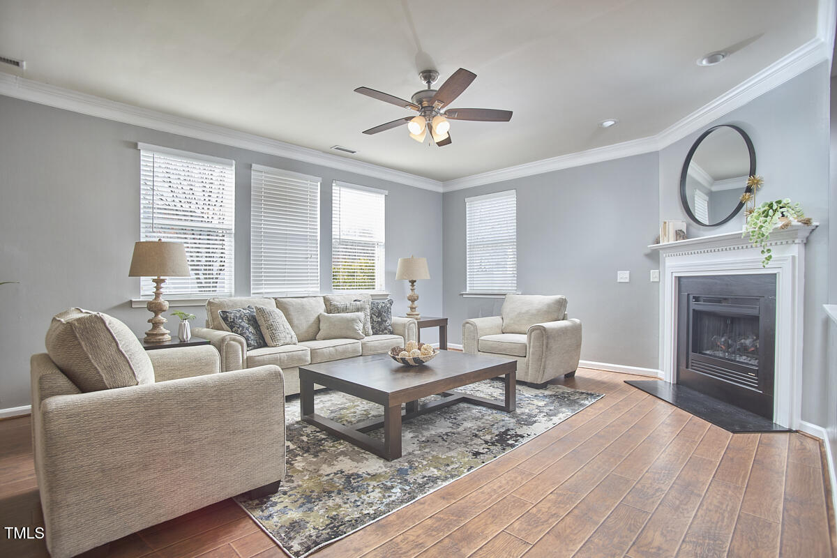 442 Steel Hopper Way Garner, NC 27529 - Photo 7 of 45 a living room with furniture a fireplace and a large window