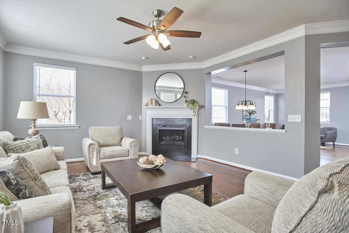 442 Steel Hopper Way Garner, NC 27529 - Photo 8 of 45 a living room with furniture a fireplace and a large window
