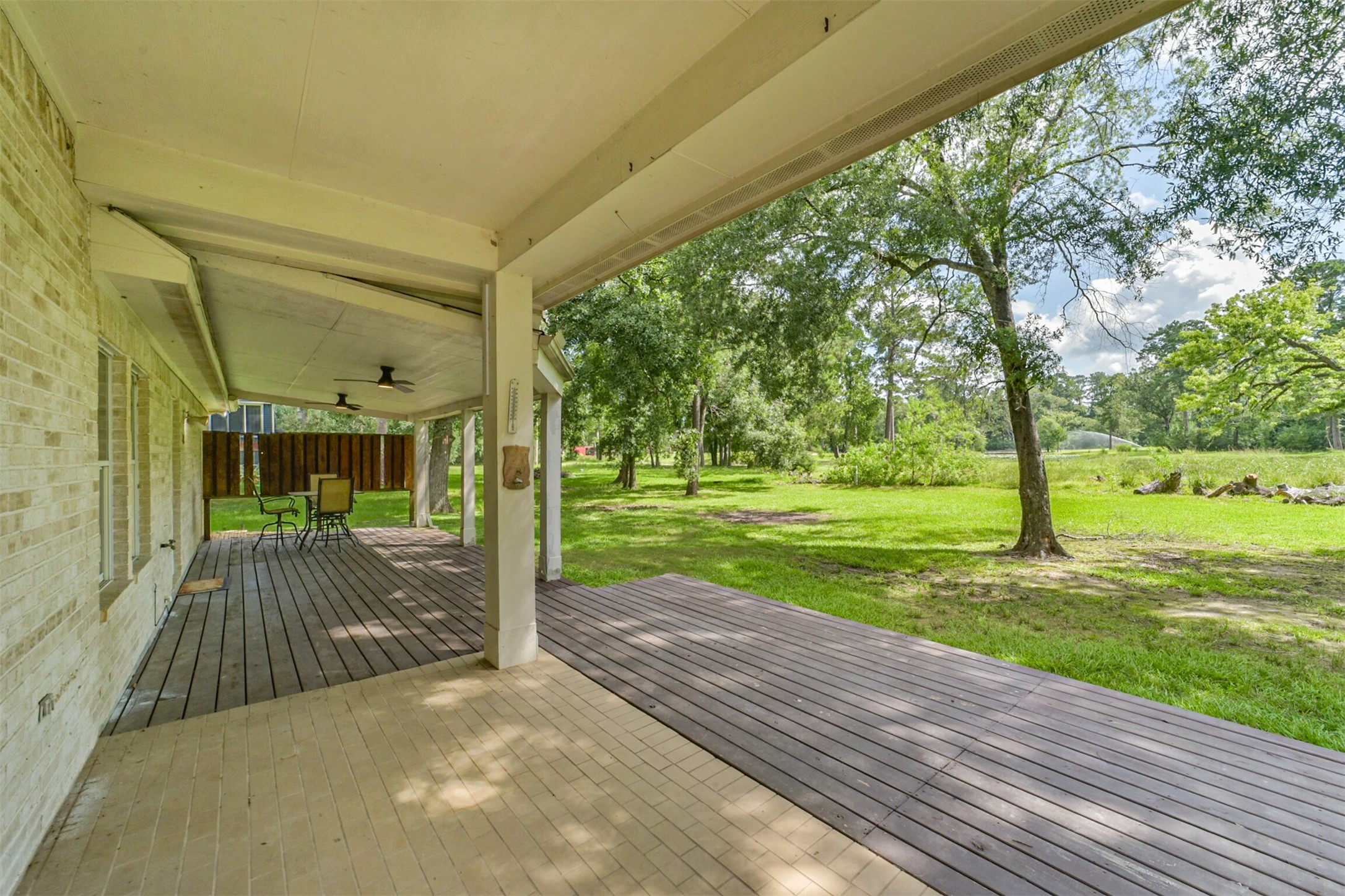 27322 Afton Way Huffman, TX 77336 - Photo 43 of 50 Covered back patio offers the perfect space for outdoor dining, entertaining, or relaxing while overlooking the scenic backyard.