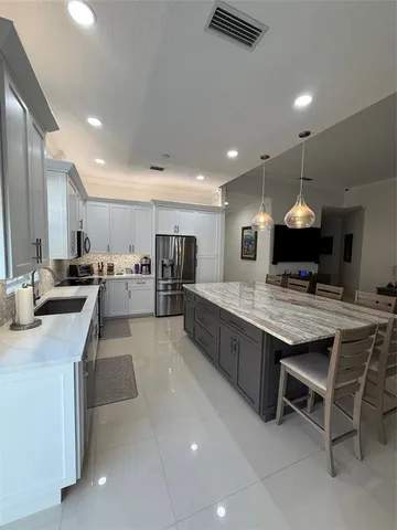 a large kitchen with a table and chairs