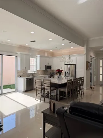a large kitchen with a table and chairs