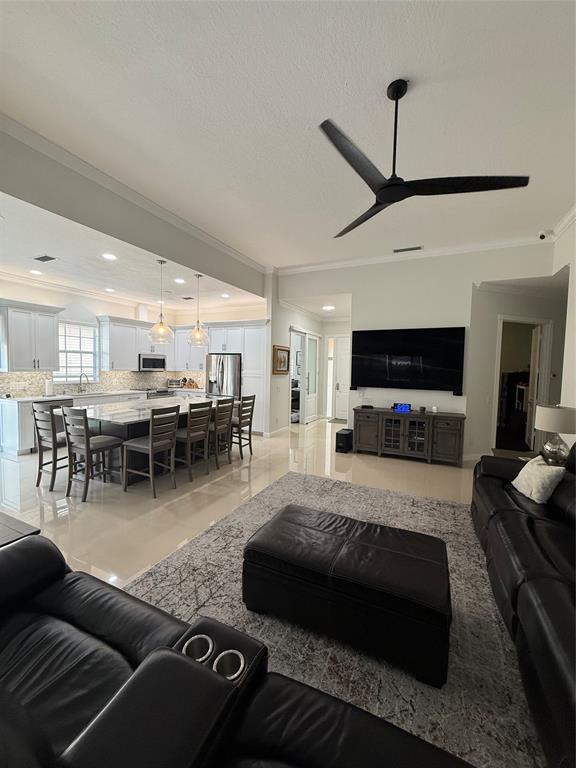 2752 Irma Lake Drive West Palm Beach, FL 33411 - Photo 15 of 38 a living room with furniture and a flat screen tv