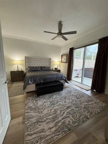 a living room with a bed furniture and a ceiling fan