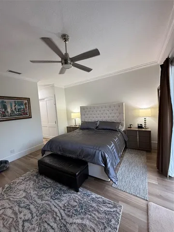 a bedroom with a bed and a tv