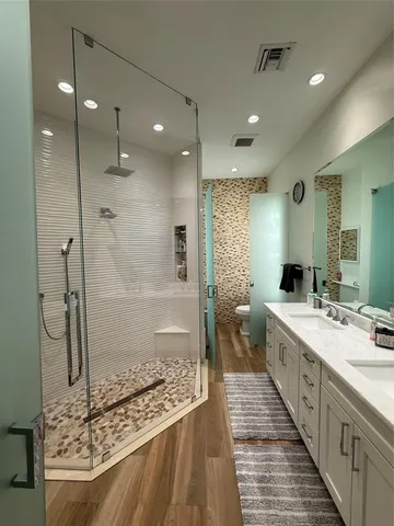 a large bathroom with a tub sink shower and a mirror
