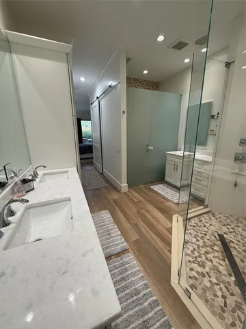 a bathroom with a sink a mirror and a shower