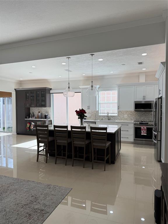 2752 Irma Lake Drive West Palm Beach, FL 33411 - Photo 6 of 38 a kitchen with lots of counter top space and chairs