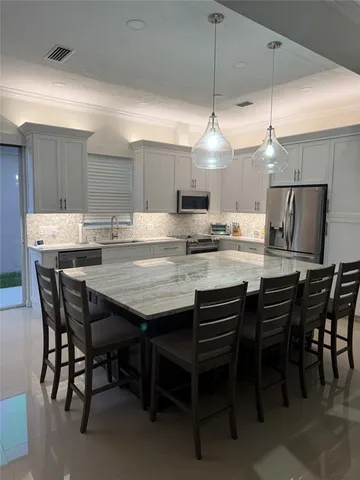 a dining table with chairs and window