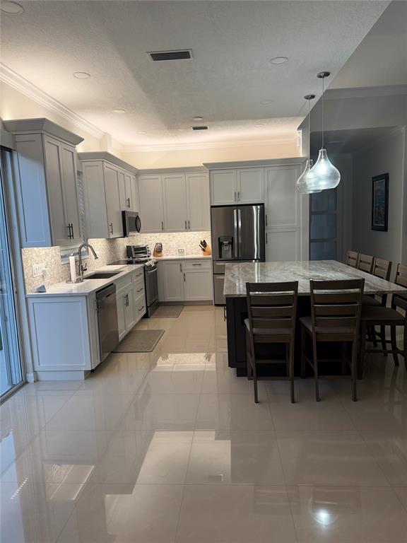 2752 Irma Lake Drive West Palm Beach, FL 33411 - Photo 10 of 38 a kitchen with a sink stove and chairs