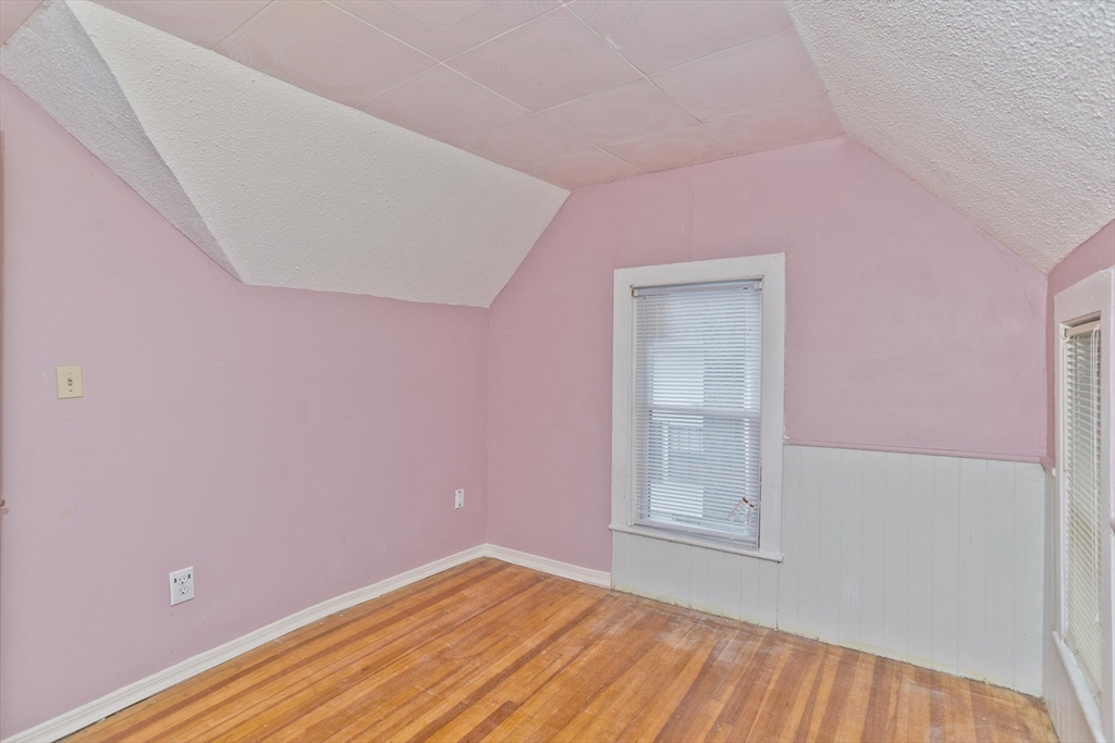 33 Forest Street Springfield, MA 01108 - Photo 20 of 39 a view of an empty room with wooden floor and a window