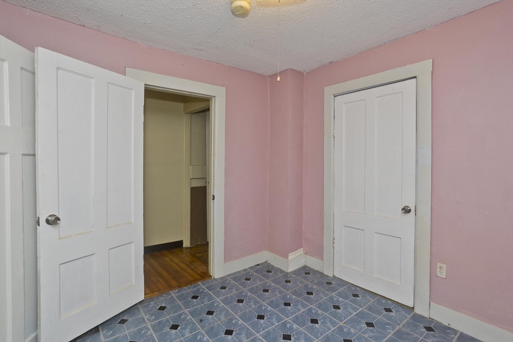 33 Forest Street Springfield, MA 01108 - Photo 26 of 39 a bedroom with a bed and a dresser