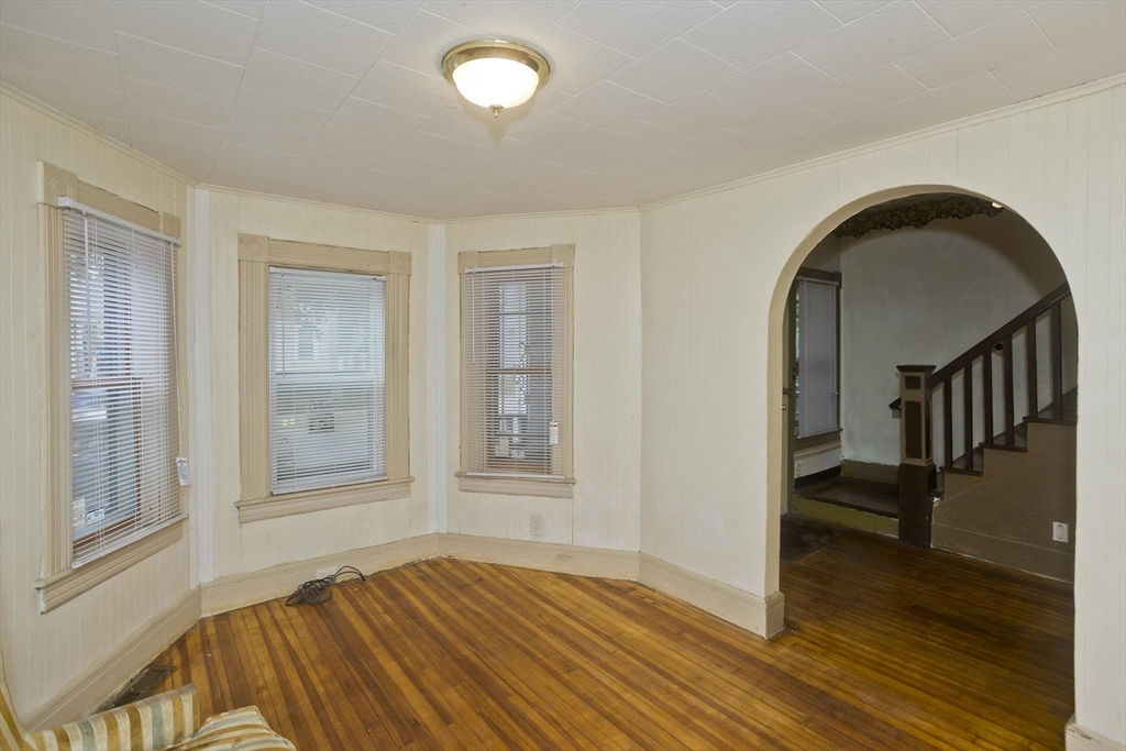 33 Forest Street Springfield, MA 01108 - Photo 3 of 39 a view of empty room with wooden floor and fan