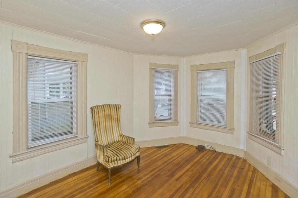 33 Forest Street Springfield, MA 01108 - Photo 5 of 39 an empty room with wooden floor and windows