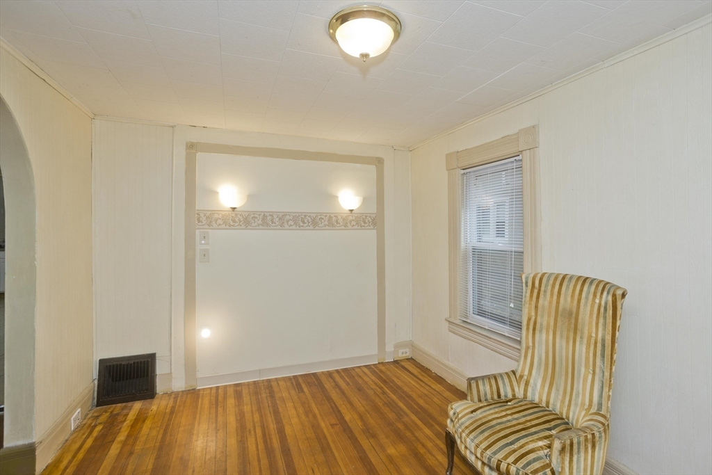 33 Forest Street Springfield, MA 01108 - Photo 6 of 39 a bedroom with a bed and a chandelier