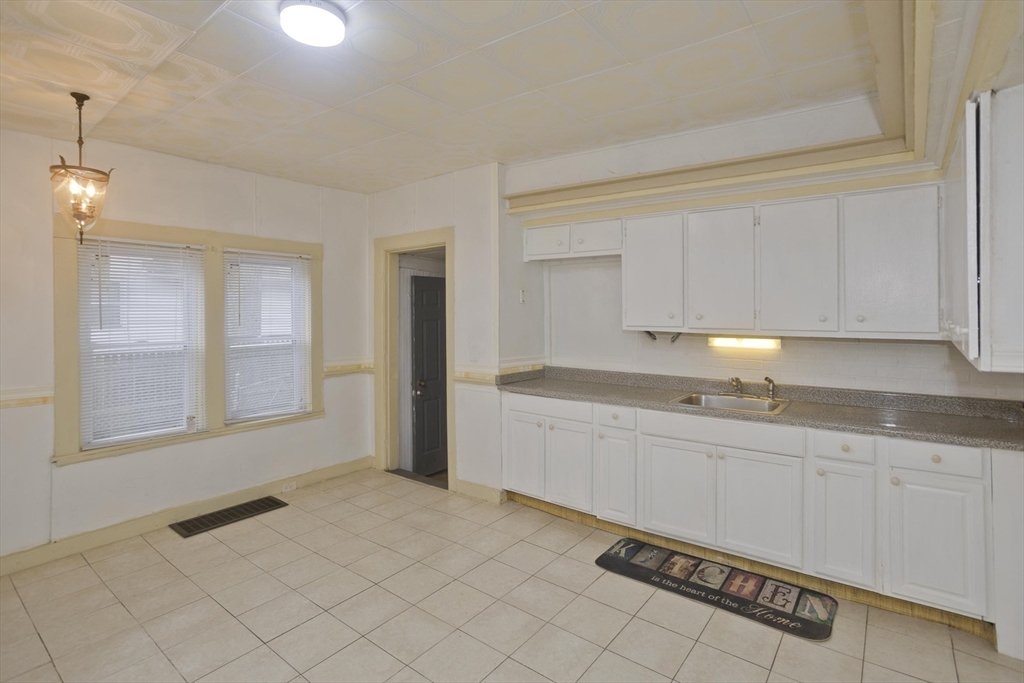 33 Forest Street Springfield, MA 01108 - Photo 7 of 39 a large white kitchen with granite countertop white cabinets and a granite counter tops