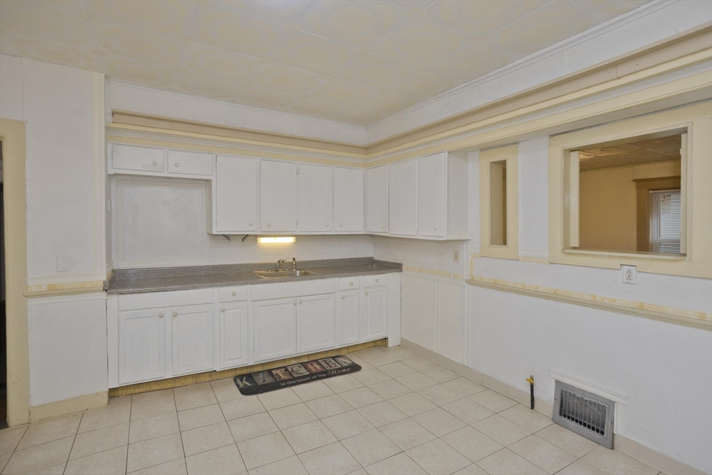 33 Forest Street Springfield, MA 01108 - Photo 9 of 39 a kitchen with granite countertop white cabinets and white appliances