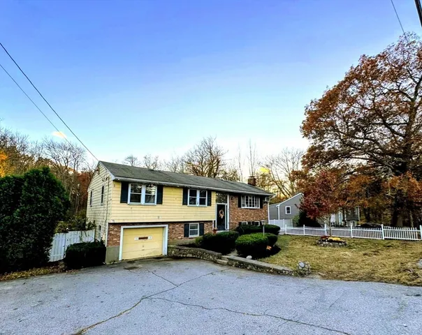 a front view of a house with a yard garage and outdoor seating
