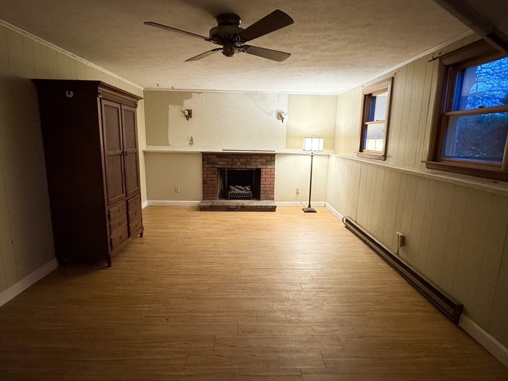 441 Grove Street Braintree, MA 02184 - Photo 5 of 13 a view of a livingroom with wooden floor and a fireplace