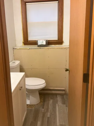 a bathroom with a toilet a sink and a window