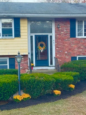 a front view of a house with garden