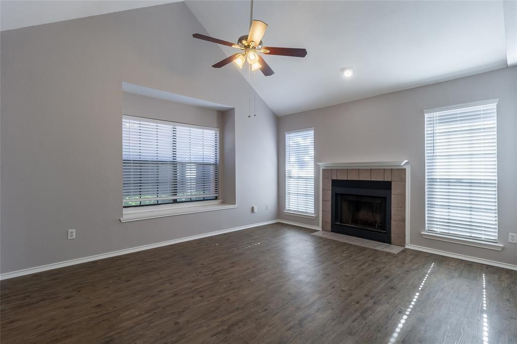 449 Harris Street, Unit 103C Coppell, TX 75019 - Photo 9 of 17 living room with fireplace, window seat, vaulted ceiling